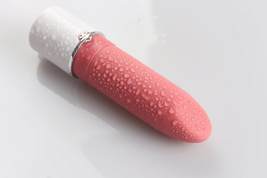 Pink and white waterproof vibrator with water droplets.