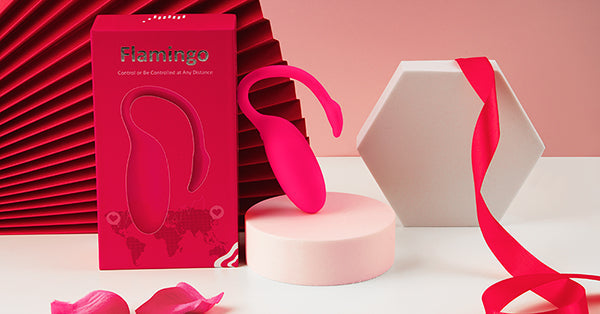 Pink Magic Flamingo vibrator and box on a red display.