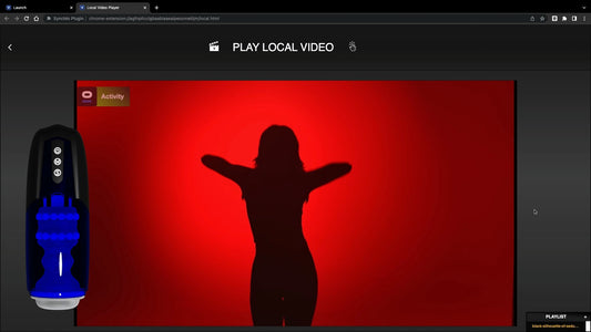 Black Xone male stroker beside a laptop video player.