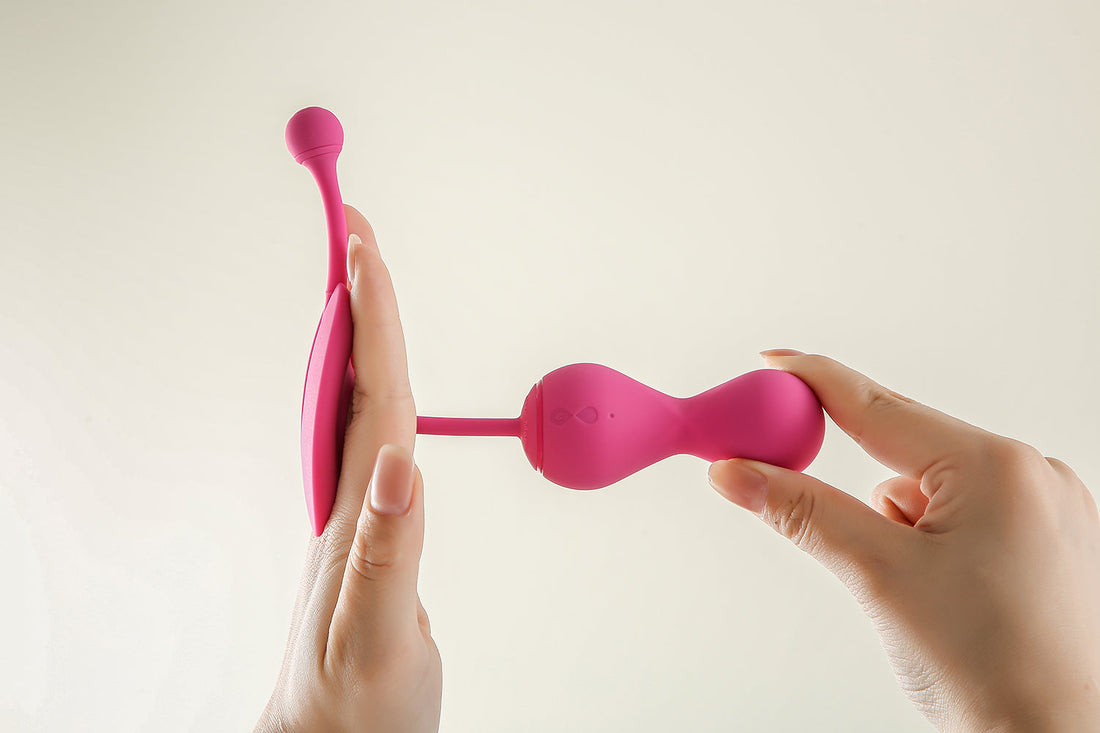 Hands holding a pink Kegel Master device.