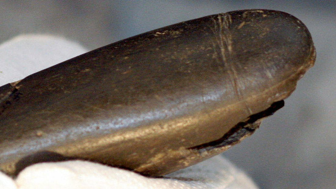 Close-up of an ancient phallic artifact.