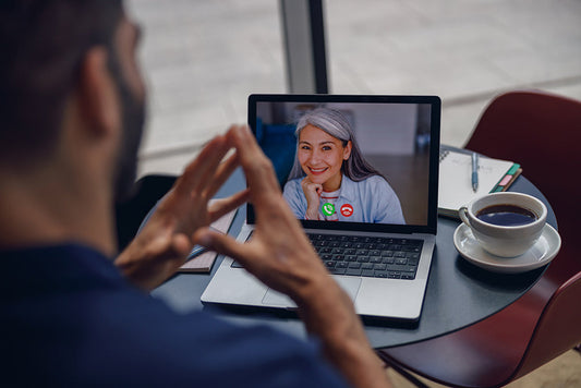 Laptop video call between two people.
