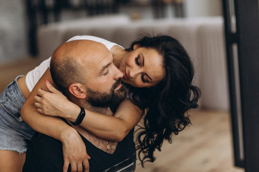 Couple embracing indoors.