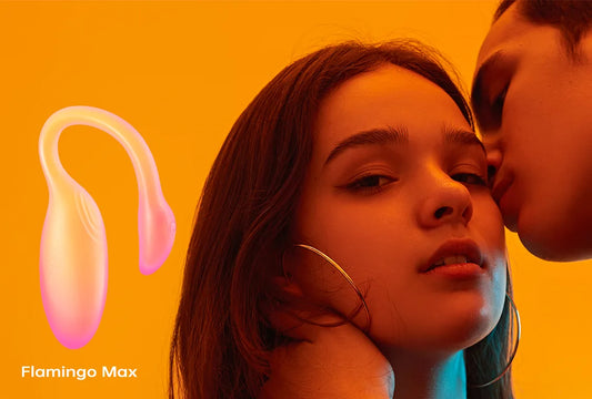Magic Flamingo Max vibrator beside a couple against an orange background.