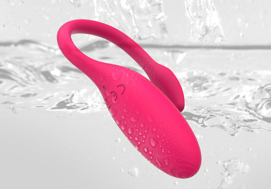 Pink waterproof wearable vibrator with water droplets.