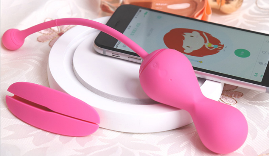 Pink Kegel Master device and phone on a white platform.