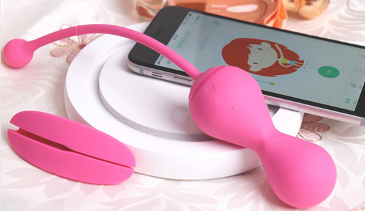 Pink Kegel Master device and phone on a white platform.