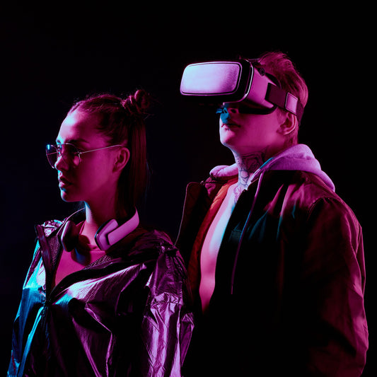 Two people wearing virtual reality headsets against a dark background.