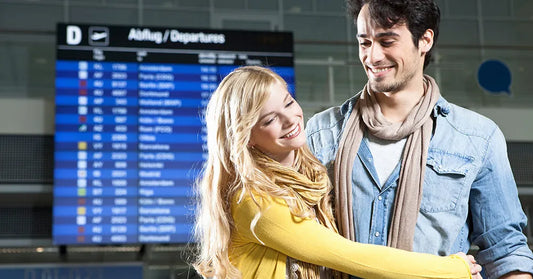 Couple embracing after meeting at an airport.