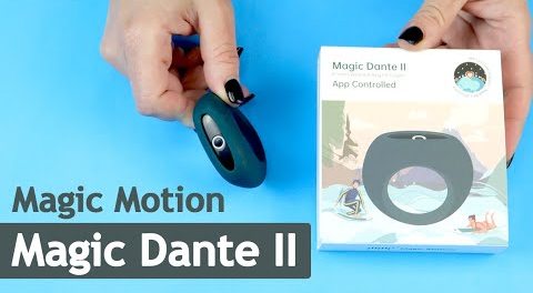 Hands holding a dark green Magic Dante II cock ring and product box.