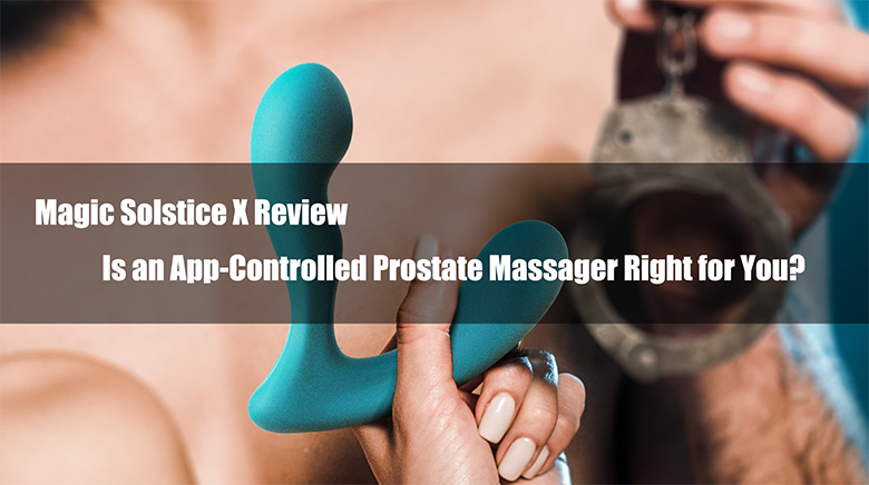 Hand holding a green prostate massager in front of an open cuff.