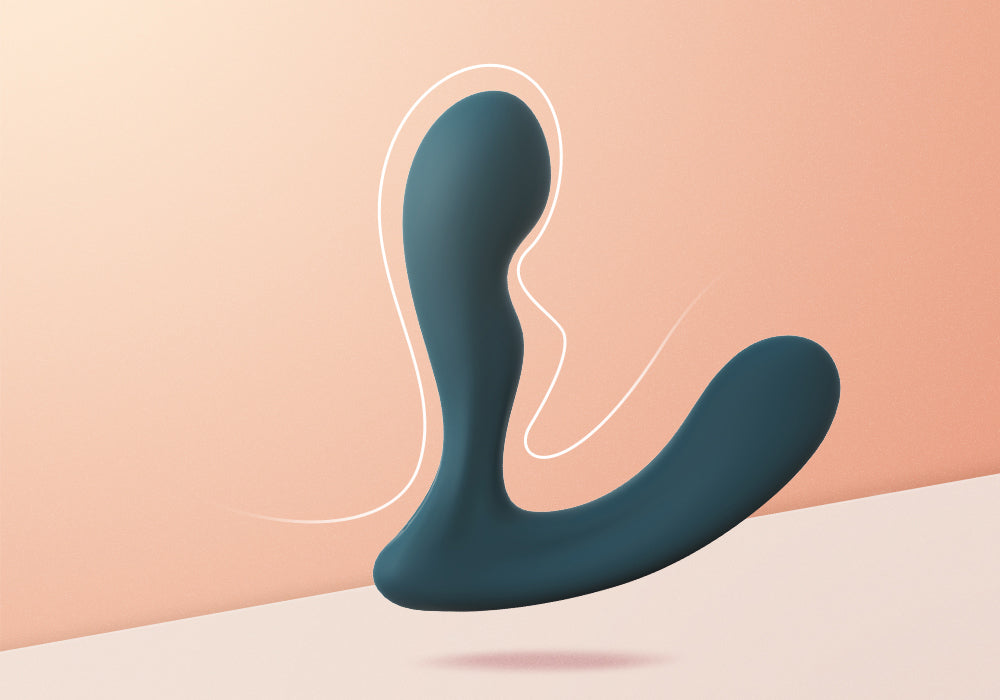 Dark green prostate massager on a peach background.