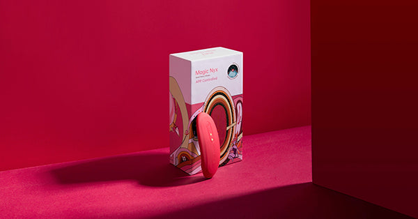Pink Magic Nyx vibrator and product box on a red background.