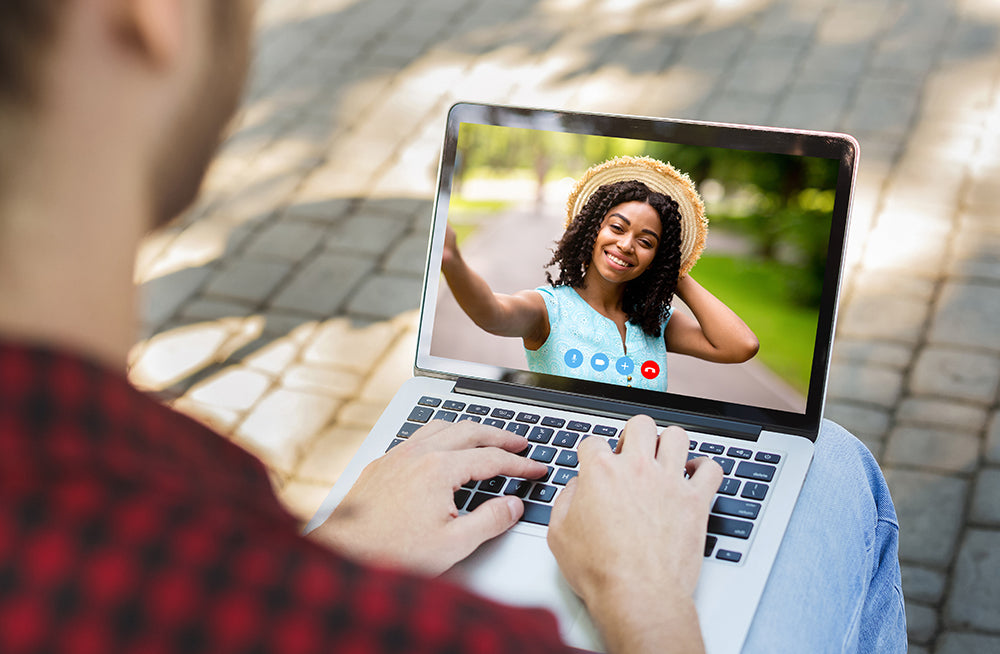 Laptop video call with a smiling woman.