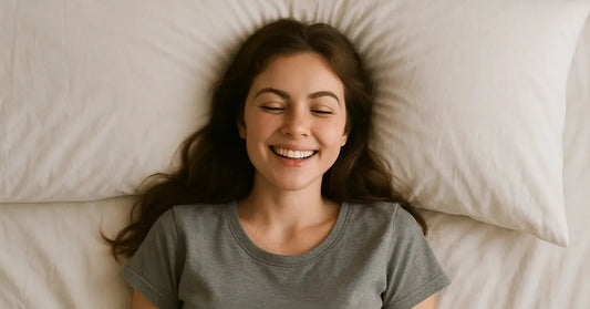 Person resting comfortably on a bed in soft daylight.