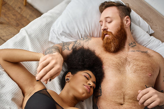 Couple relaxing together in bed.