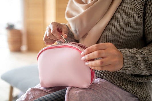 Person opening a pink travel case.