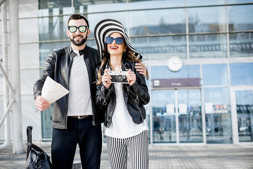 Couple at an airport holding travel documents.