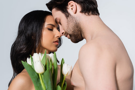 Couple embracing with white tulips.