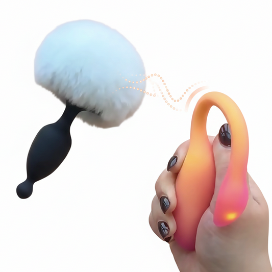 Hand holding a colorful brush flamingo max with a white fluffy end, magic bunny on a white background