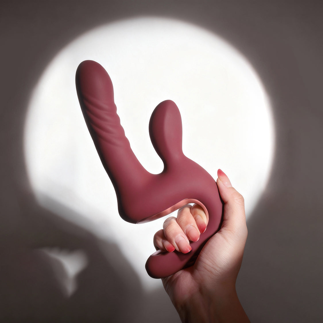 Red Magic Duet held by its open-frame handle to show product scale