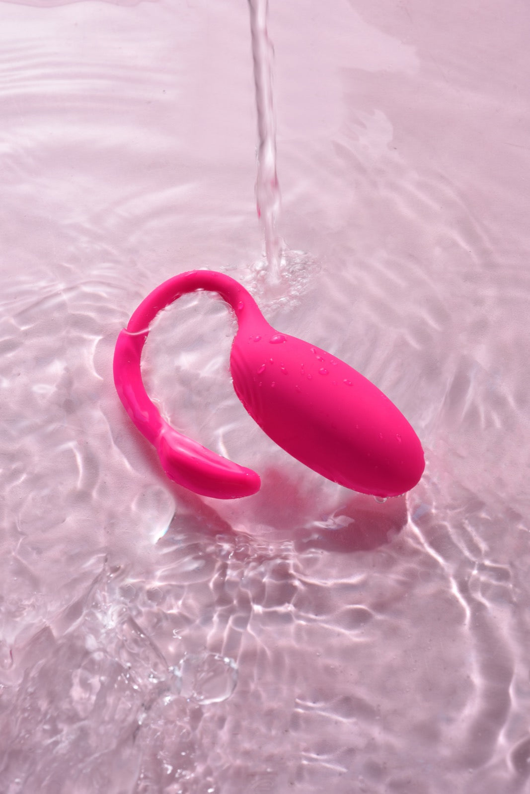 Magic Flamingo wearable vibrator being rinsed for surface cleaning