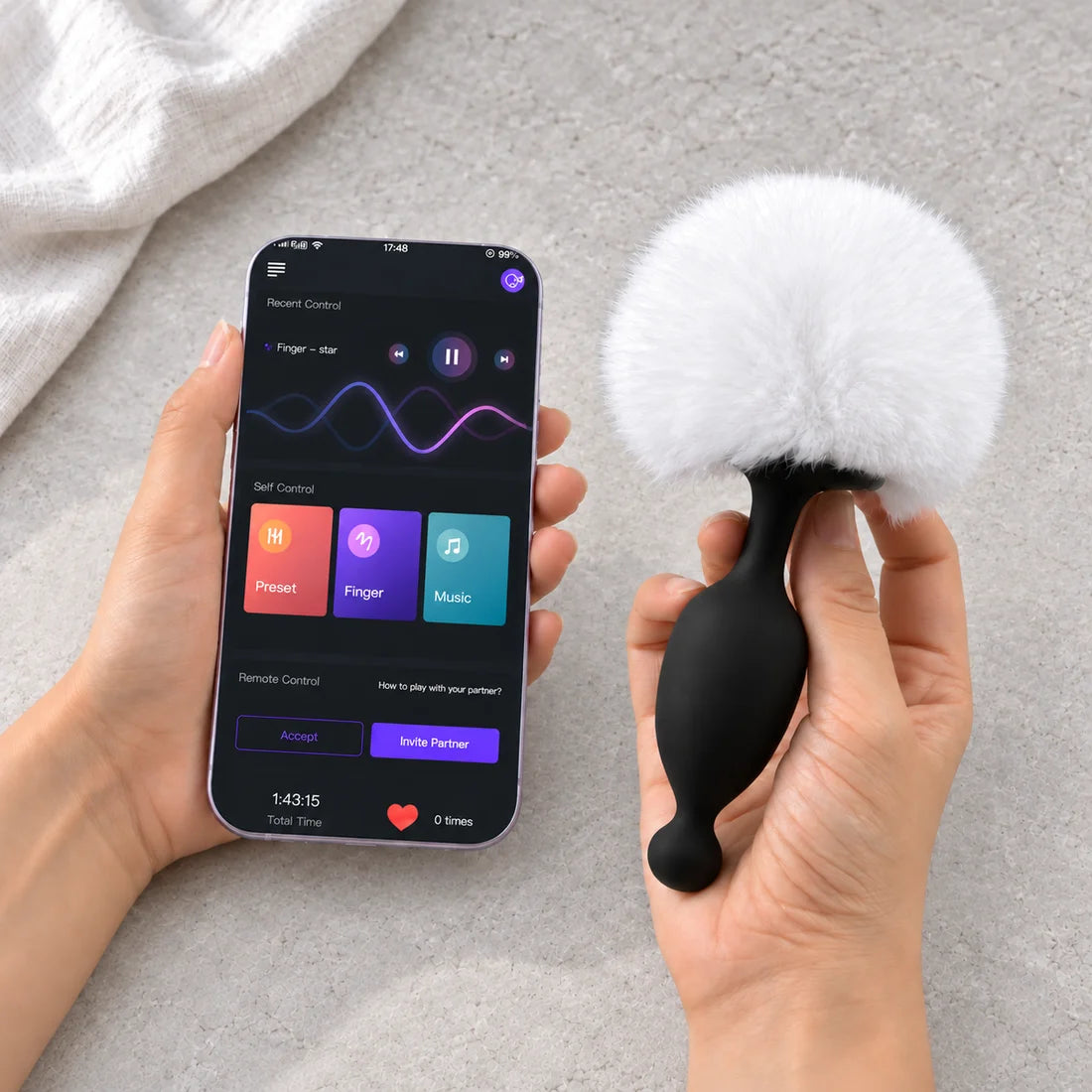 Magic Bunny with a white plush tail held beside the app on a phone