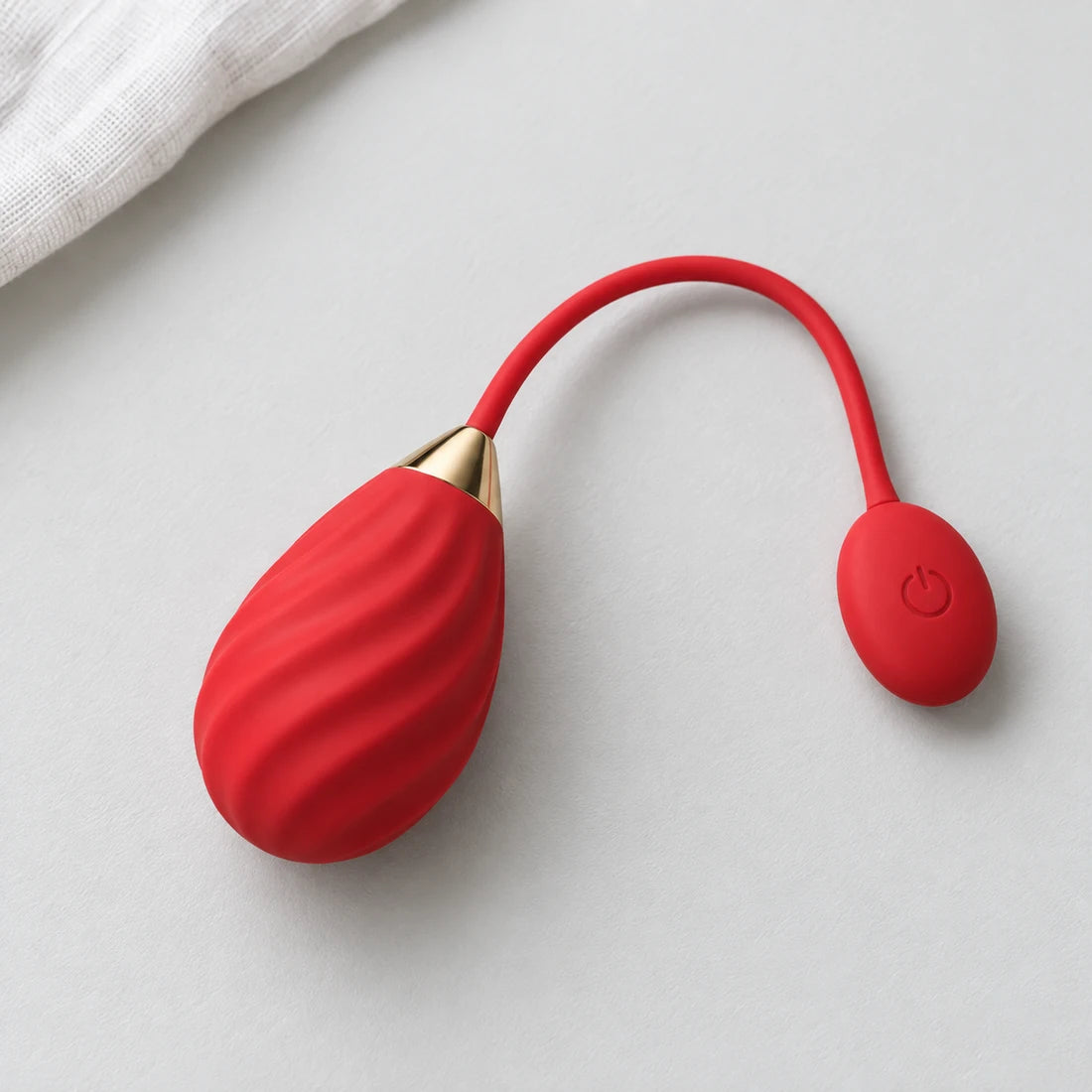 Full red Magic Sundae showing spiral grooves and its connected button end