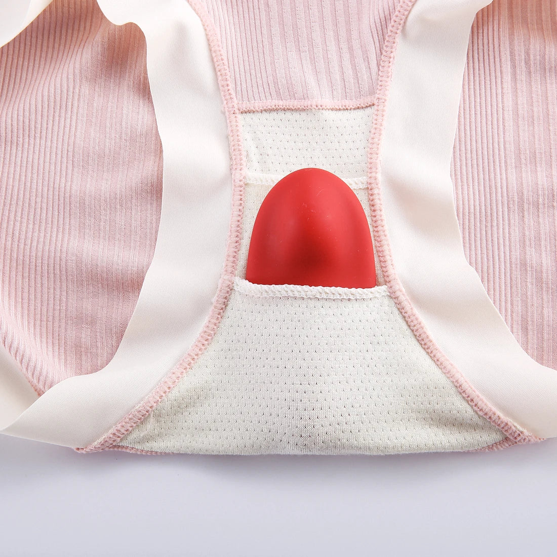 Red Magic Nyx positioned inside the inner panel of pink close-fitting underwear