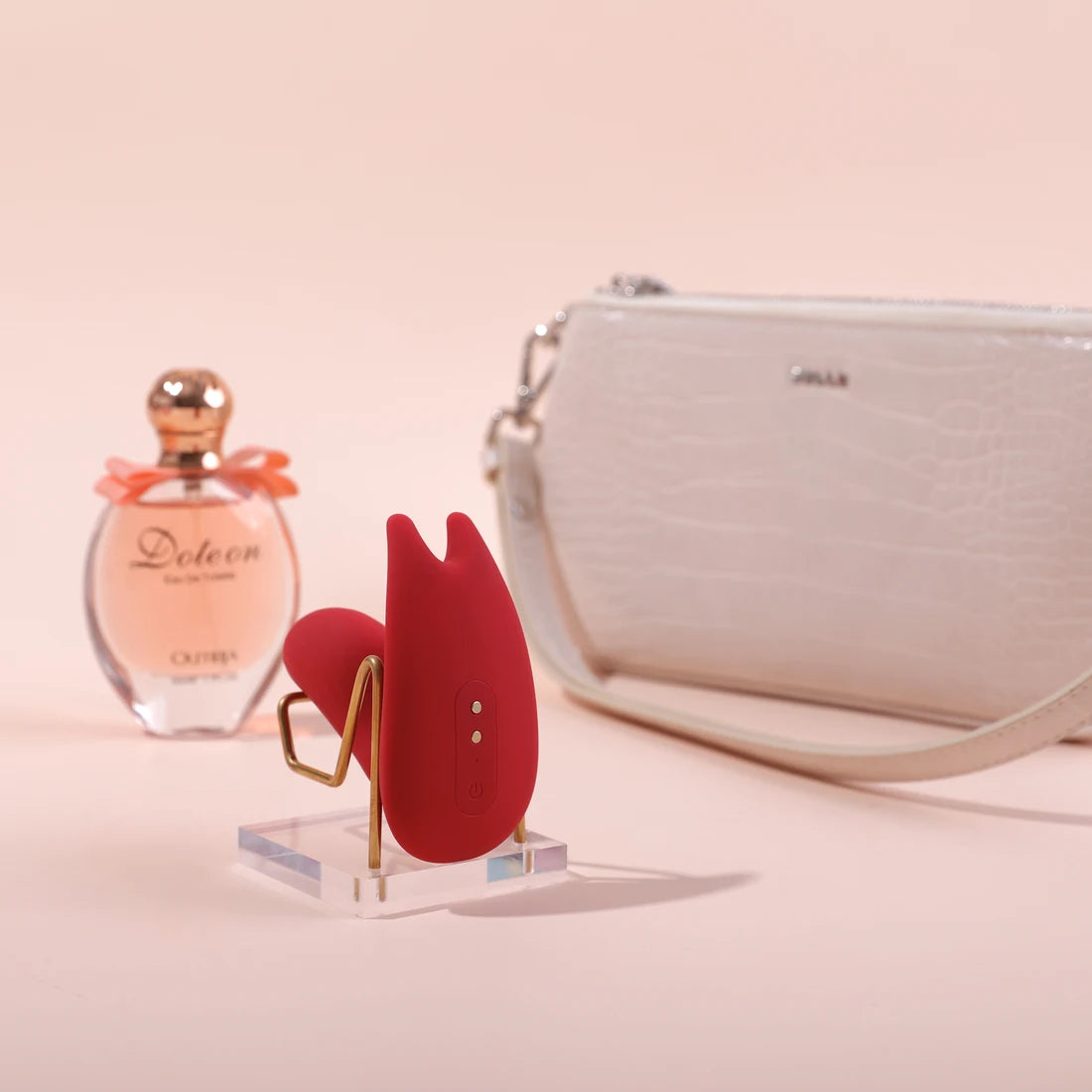 Red Magic Umi displayed beside a small handbag and perfume